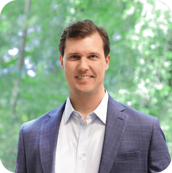 Derek Hoselton Headshot with green trees in background